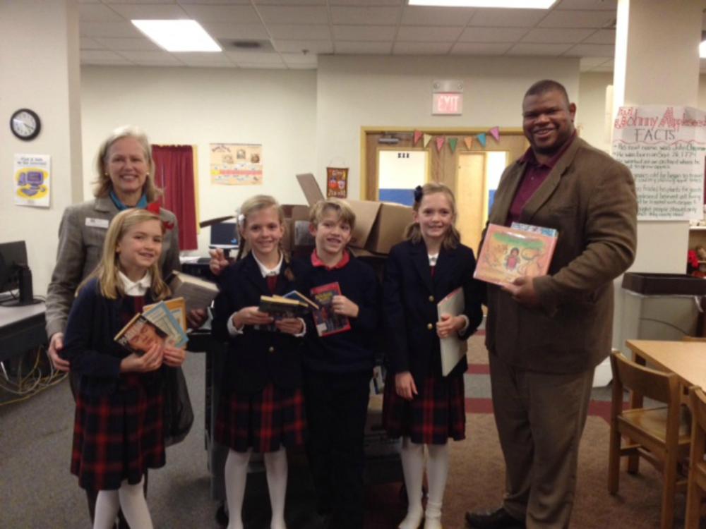 Wonderland Booksavers with Martha Lord, director of Pequot Library and Mr. White, headmaster of New Beginnings Family Academy, a book recipient